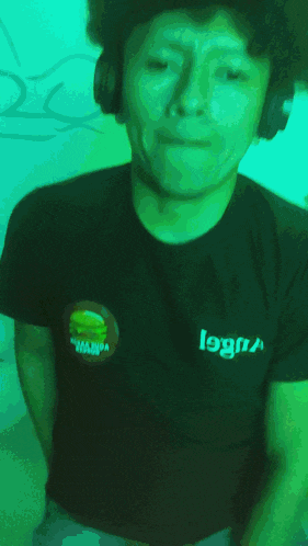 a man wearing headphones and a black shirt with the word logan on it