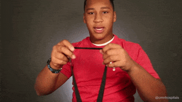 a man in a red shirt is holding a black strap with the letter p on it