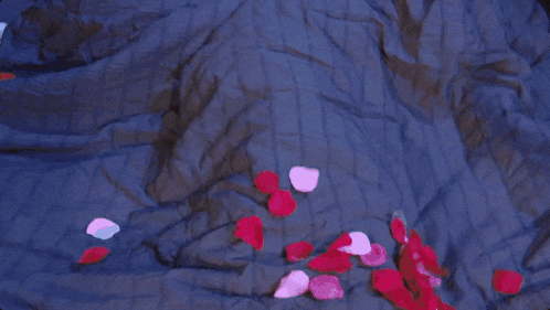 a shirtless man and woman are laying in bed