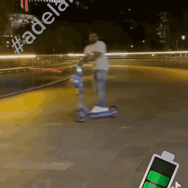 a man is riding a scooter with the hashtag #adelaide on the side