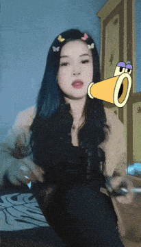 a woman with a cartoon face on her head and a yellow tube coming out of her mouth