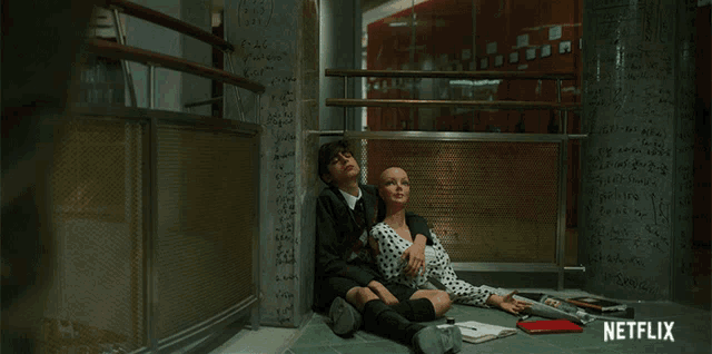 a boy and a girl are sitting on the floor with a netflix logo in the corner