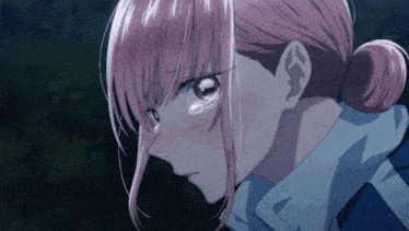 a close up of a girl with pink hair and a bun