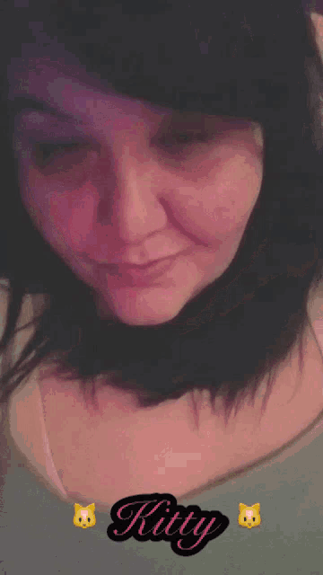 a close up of a woman 's face with the name kirty written on the bottom