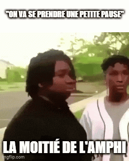 two men are standing next to each other on a sidewalk and one of them is talking to the other .