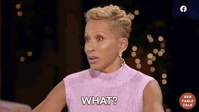 a woman wearing a pink sweater says what