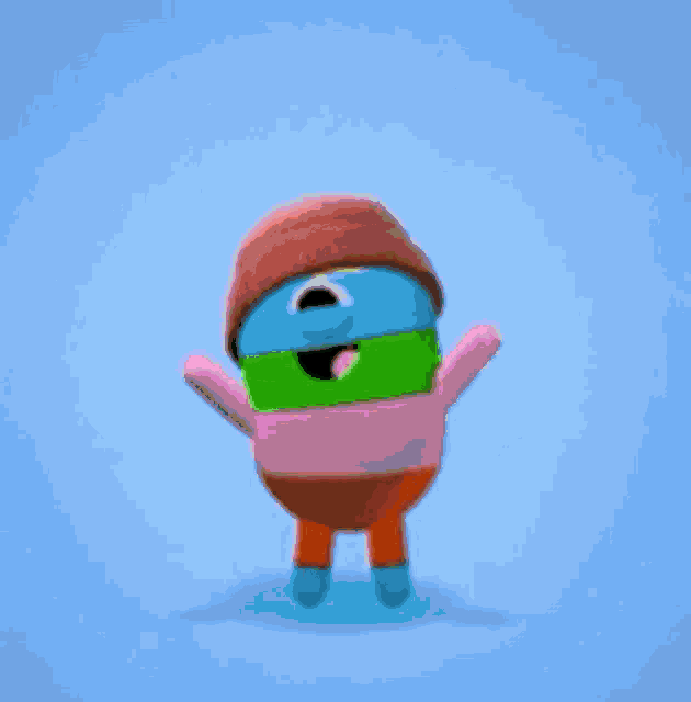 a cartoon character wearing a hat , sweater , and pants is dancing on a green background .