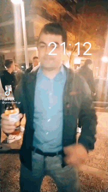 a man is dancing in front of a screen that says tik tok
