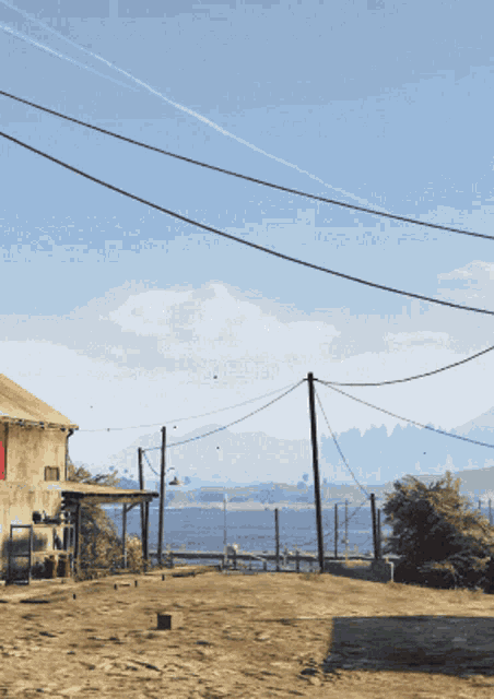 a dirt road with a building in the background