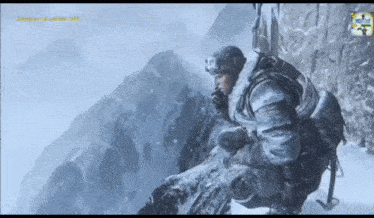 a man in a military uniform is kneeling down in the snow