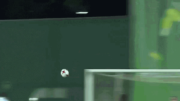 a soccer ball is flying through the air in front of a soccer goal