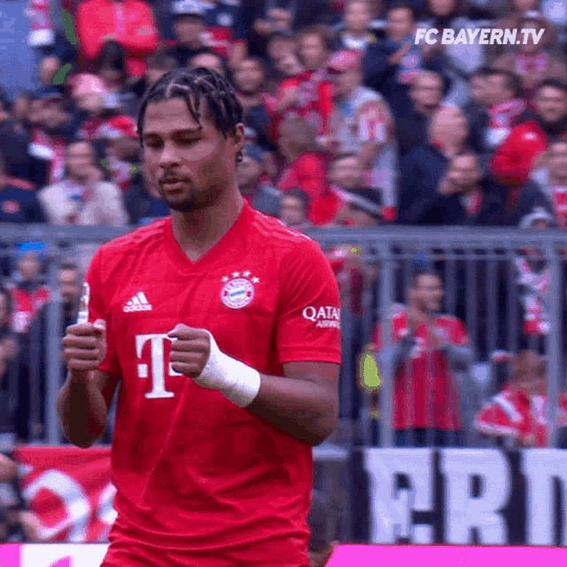 a soccer player wearing a red shirt that says qatar airlines on it