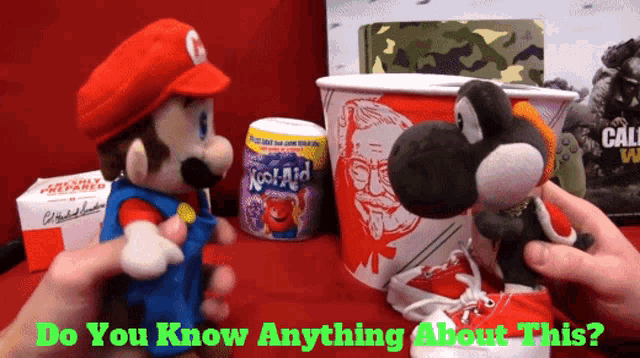 a person is holding a stuffed mario and a stuffed yoshi with the words " do you know anything about this " below them