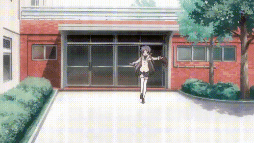 a girl is standing in front of a building in a parking lot .