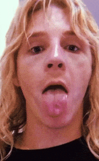 a close up of a woman 's face with her tongue out