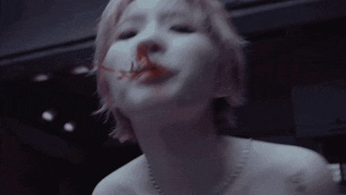 a close up of a woman 's face with a sign in the background that says ' smoking '