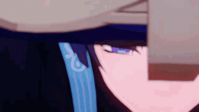 a close up of a person 's face with purple eyes and a blue shirt .