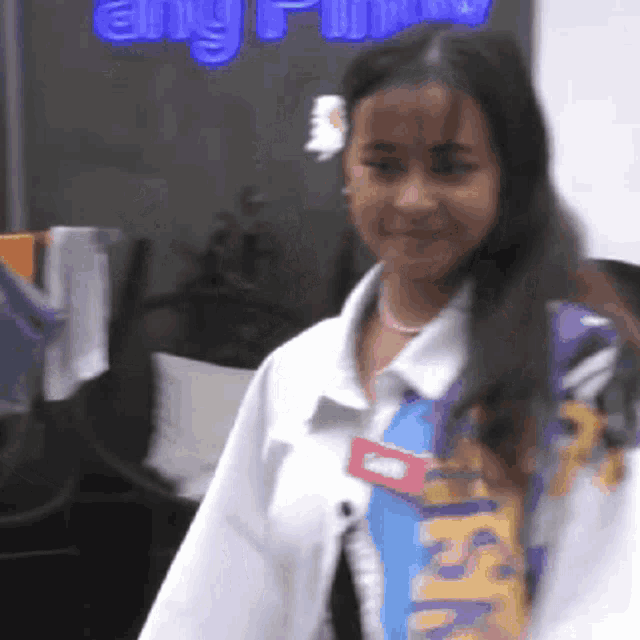 a woman wearing a name tag that says ' ash ' on it
