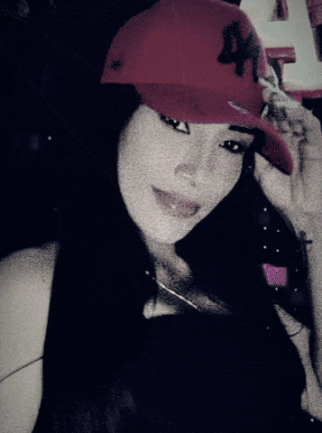 a woman wearing a red hat with the letter x on it