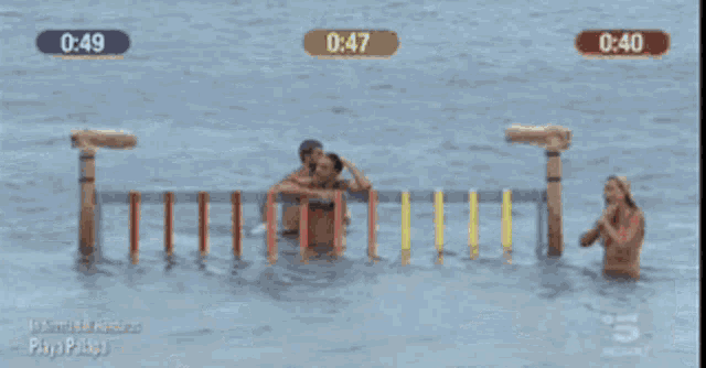 two men are standing in the water with the numbers 0:49 and 0:47 on the screen