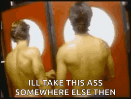 two naked men are standing next to each other in front of a mirror .