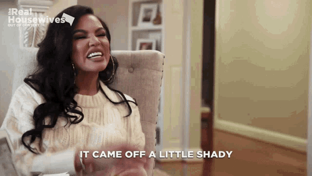 a woman sitting in a chair with the words " it came off a little shady " behind her