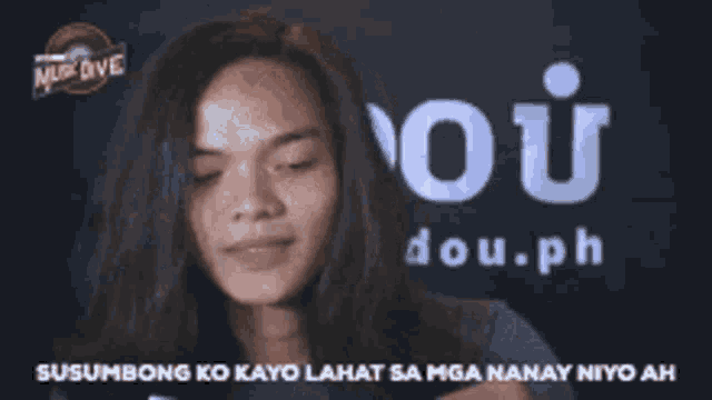 a woman holding a piece of paper with the word ou.ph on it