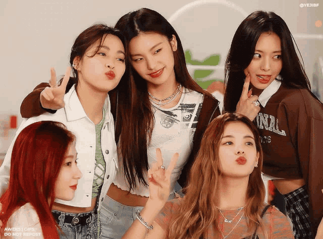 a group of girls posing for a picture with one wearing a sweatshirt that says ' seoul '