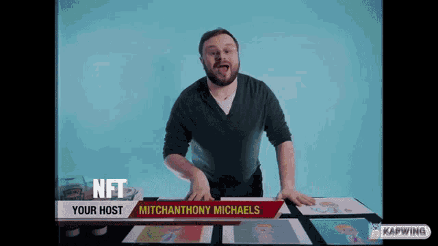 a man is standing in front of a table with a sign that says nft your host mitchanthony michaels