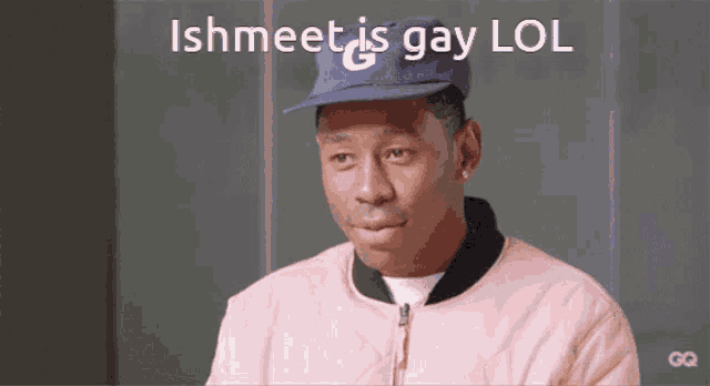 a man wearing a pink jacket and a blue hat with the words ishmeet is gay lol