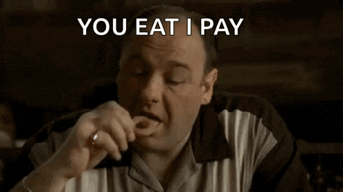a man is eating something with the words " you eat i pay " behind him