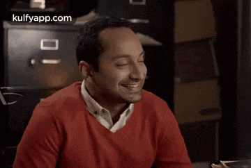 a man in a red sweater is smiling and the website kulfyapp.com is visible in the corner