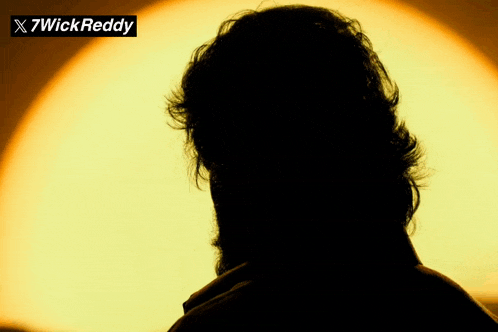 a silhouette of a man with the name 7wick reddy on the top