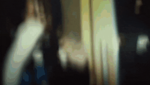 a blurry image of a person 's face with a yellow background
