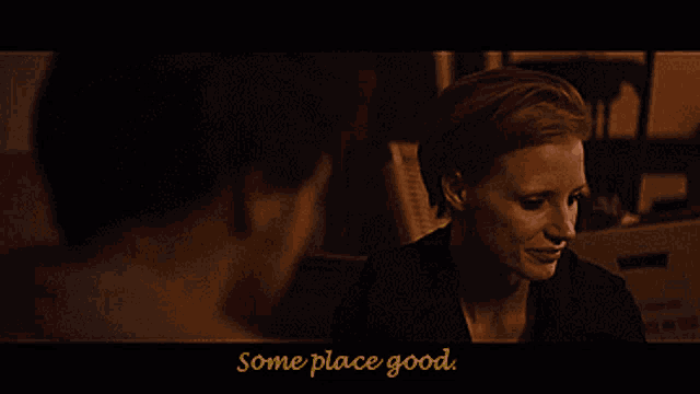 a woman is smiling in a dark room with the words " some place good " below her