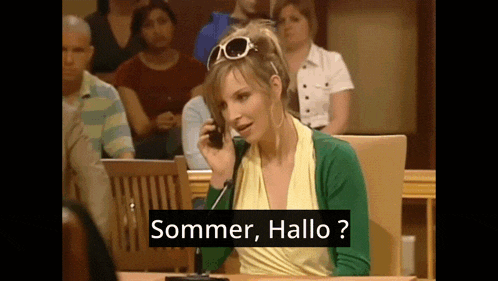 a woman in a courtroom talking on a cell phone with the words sommer hallo below her