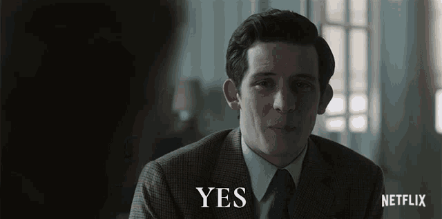 a man in a suit says yes in front of a netflix logo