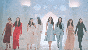 a group of women standing next to each other in a line holding hands