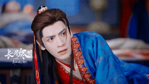 a man in a blue and red costume with chinese writing on the bottom right