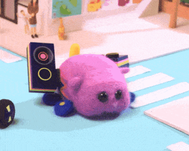 a purple stuffed animal with a speaker attached to its back