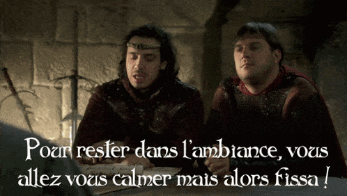 two men are sitting at a table with the words pour rester dans l' ambiance
