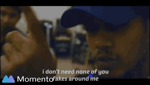 a blurry picture of a man wearing a blue hat with the words " i don t need none of you "