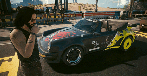 a man smoking a cigarette next to a car that says porsche on it