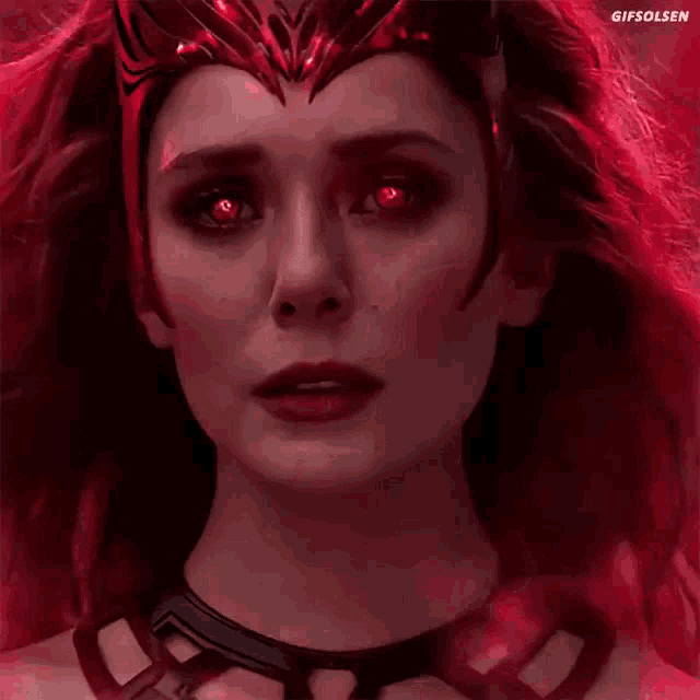 a close up of scarlet witch 's face with red eyes .