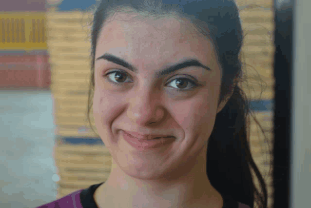 a close up of a woman 's face with a yellow sign in the background that says bingo