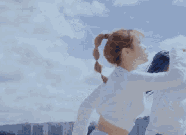 two women standing back to back with their arms outstretched