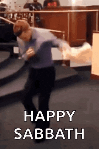 a man is dancing in a church with the words `` happy sabbath '' above him .