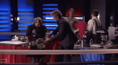 a man in a suit is standing in a boxing ring with bravo written on the table