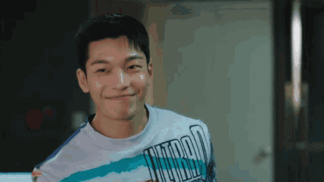 a man wearing a shirt that says ' nitro ' on it smiles