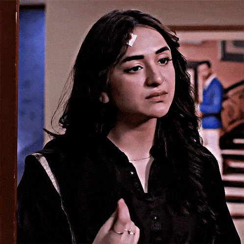 a woman with a bandage on her forehead and a nose ring